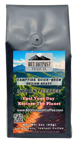 Campfire Quick-Brew medium roast instant coffee by 803 Outpost sitting on a rustic wooden table.